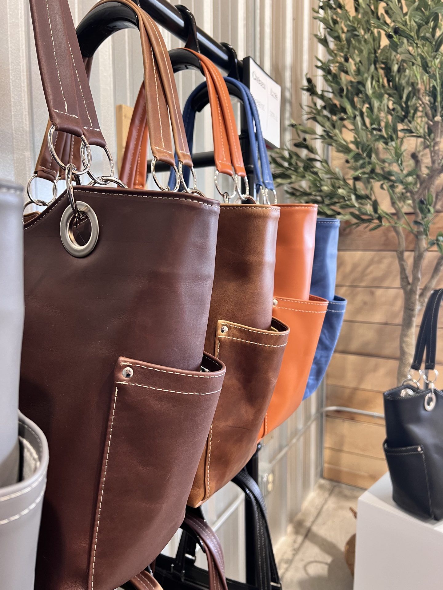 Shoulder bags hanging on a rack in the store located in newport maine