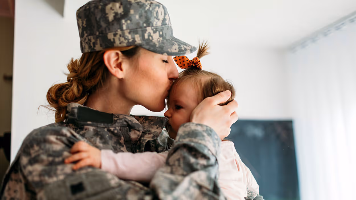 extended stay hotels for military - military woman kissing child