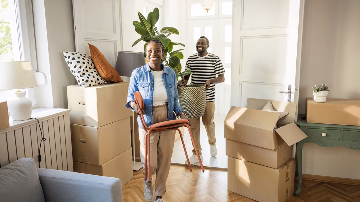 temporary housing - happy couple moving and packing