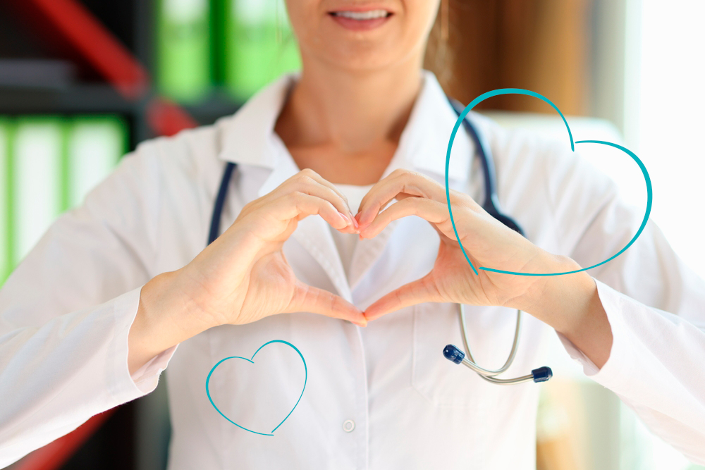 Nurse with hands in shape of a heart.