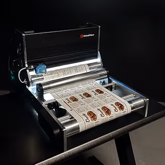 GlidePath machine printing multiple color labels with cartoon dog faces on a roll.