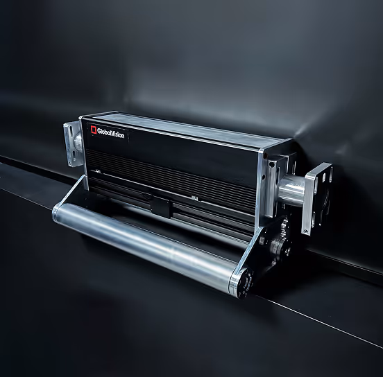 Close-up of a GlobalVision Verify Inline printing inspection device mounted on a black surface.