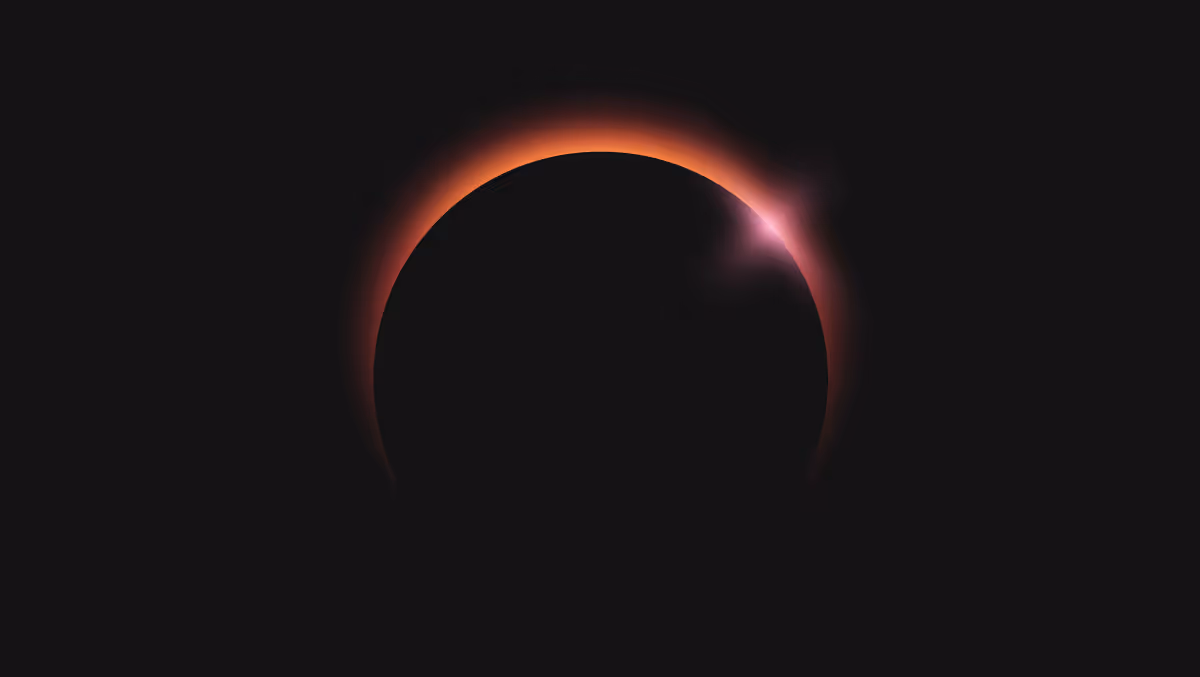 Solar eclipse with the sun’s bright corona glowing around the dark silhouette of the moon.