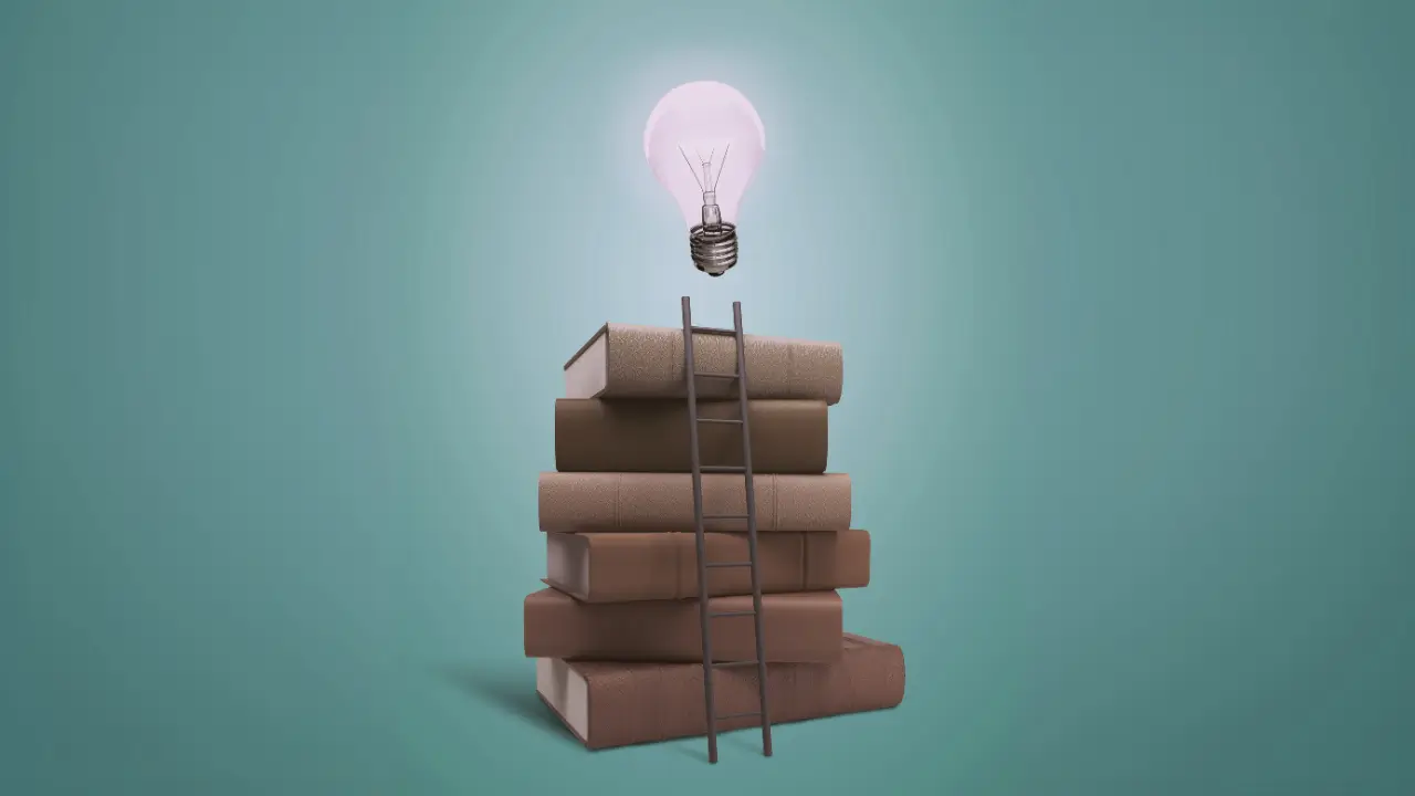 A small ladder leans up against a stack of books, above which is an illuminated light bulb.