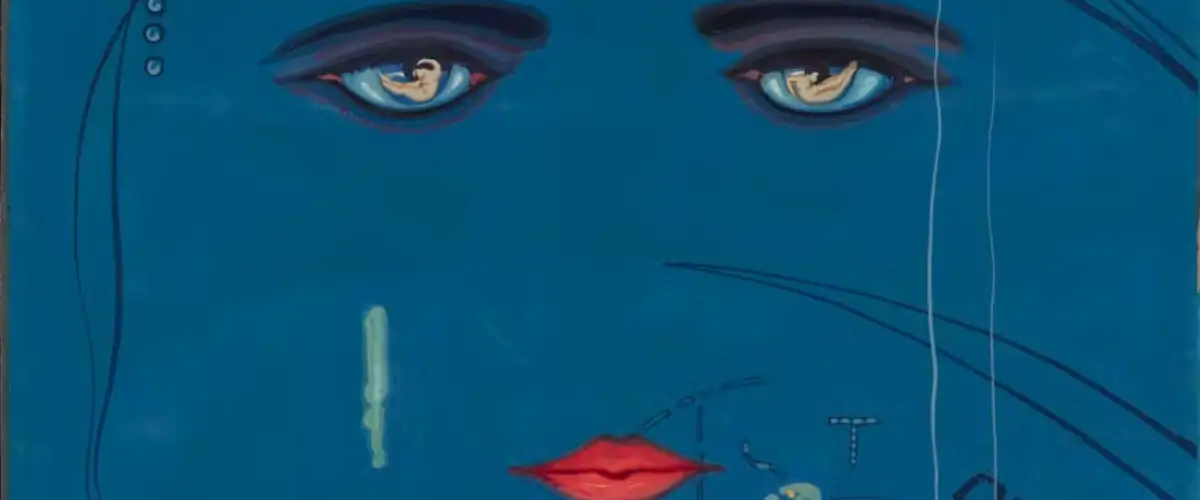 The artistic eyes and lips on a blue face of The Great Gatsby's cover art.