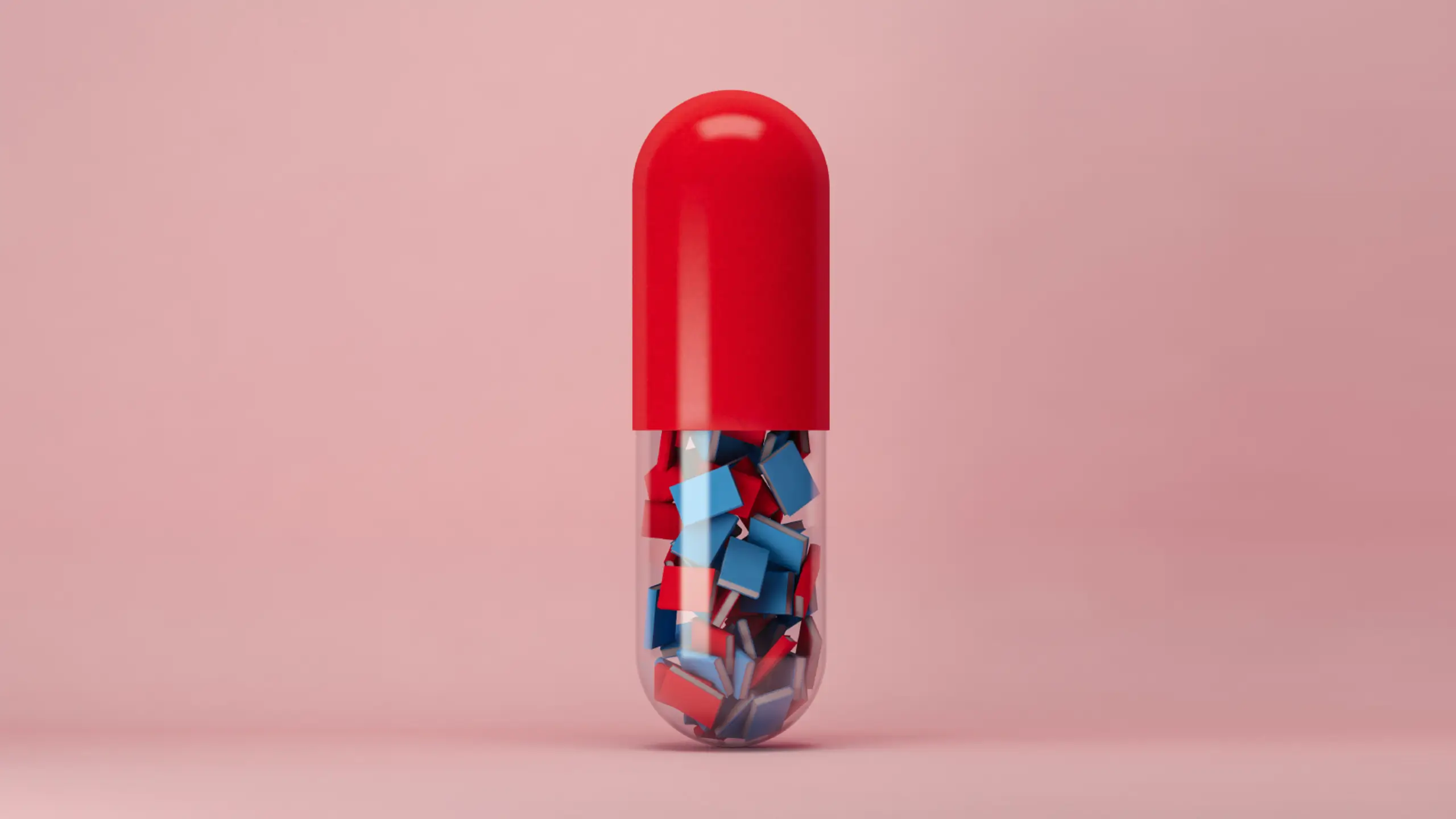 A red and transparent pill capsule containing lots of tiny red and blue books.