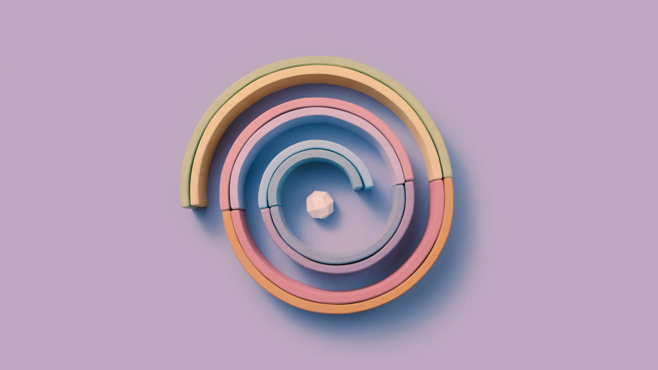 A spiral made of long colored blocks and an angular ball placed right in the center.