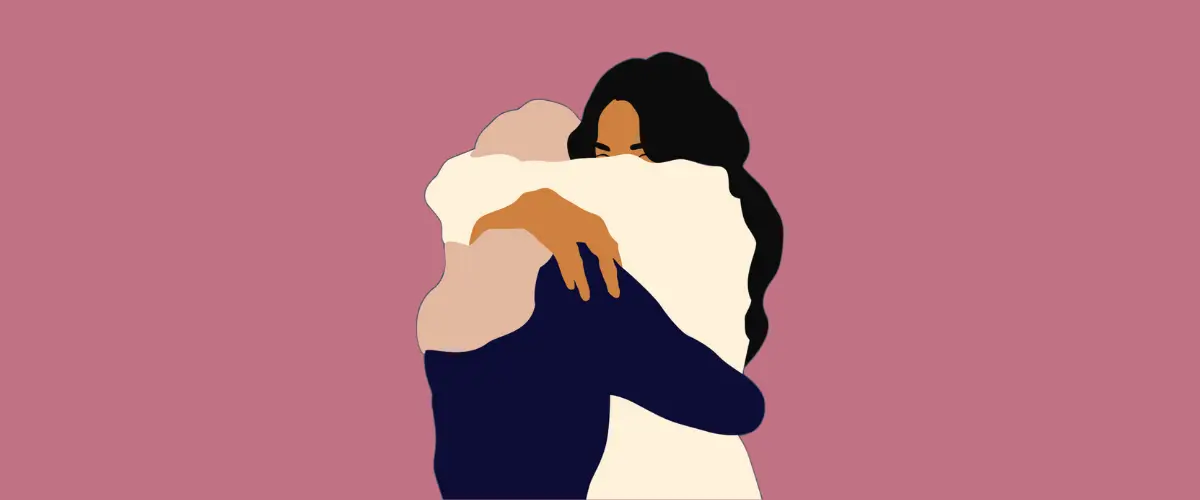 Two people with long hair hugging.