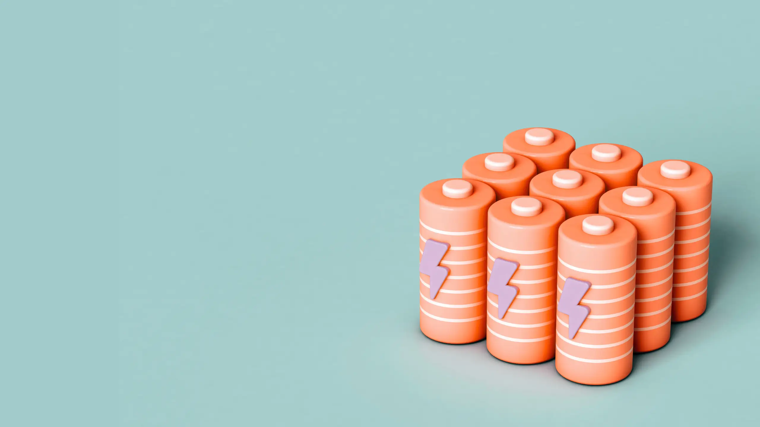 A pack of small peach-colored batteries against a turquoise background.