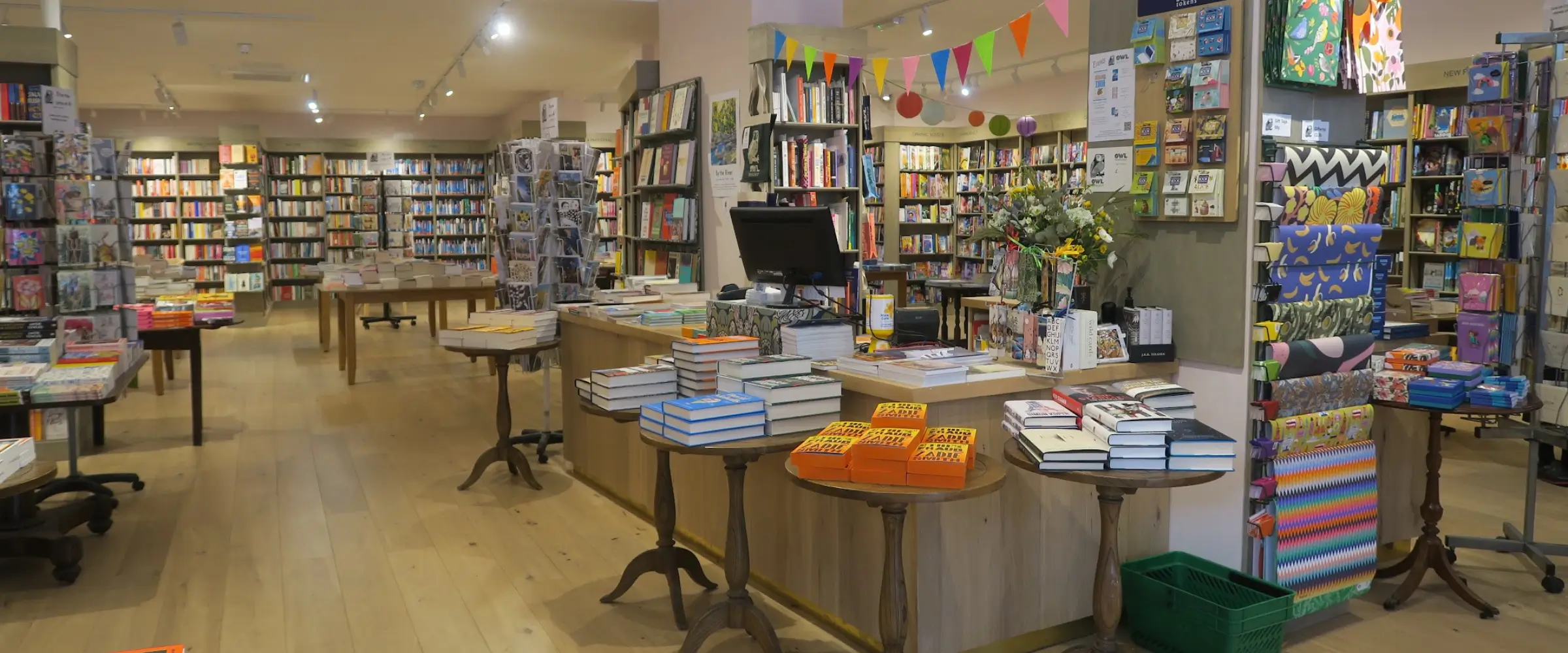 Interior shot of Owl Bookshop, London, showing many shelves and tables full of books.