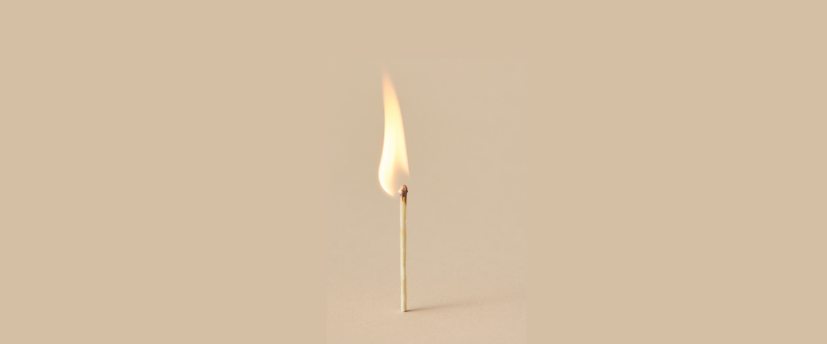 A lit match stands alone.