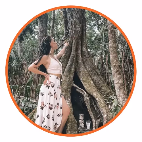 An image of reviewer, Stephanie Boland, posing near a tree.