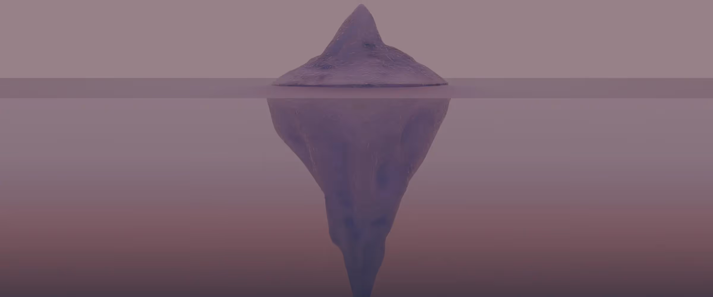 An image of an iceberg, with a larger section of the iceberg hidden beneath the water.