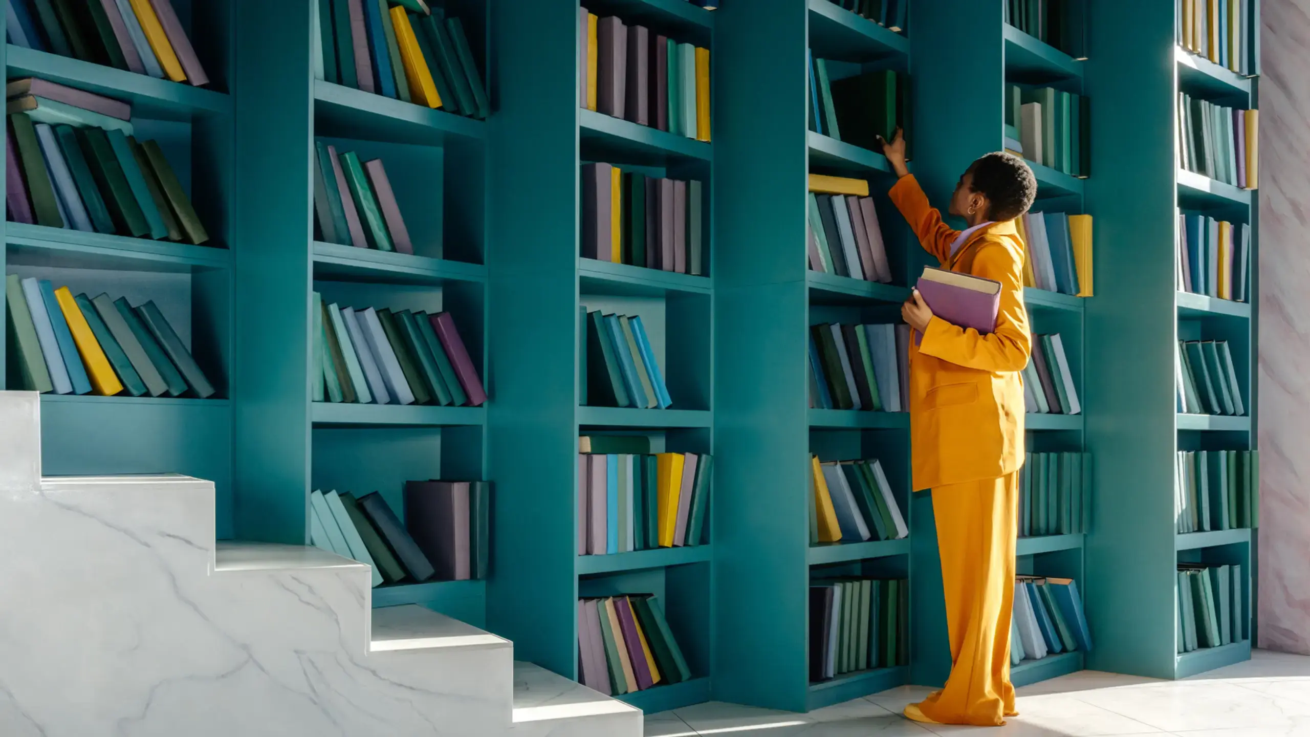 A woman in a yellow suit browses a turquoise book shelf.