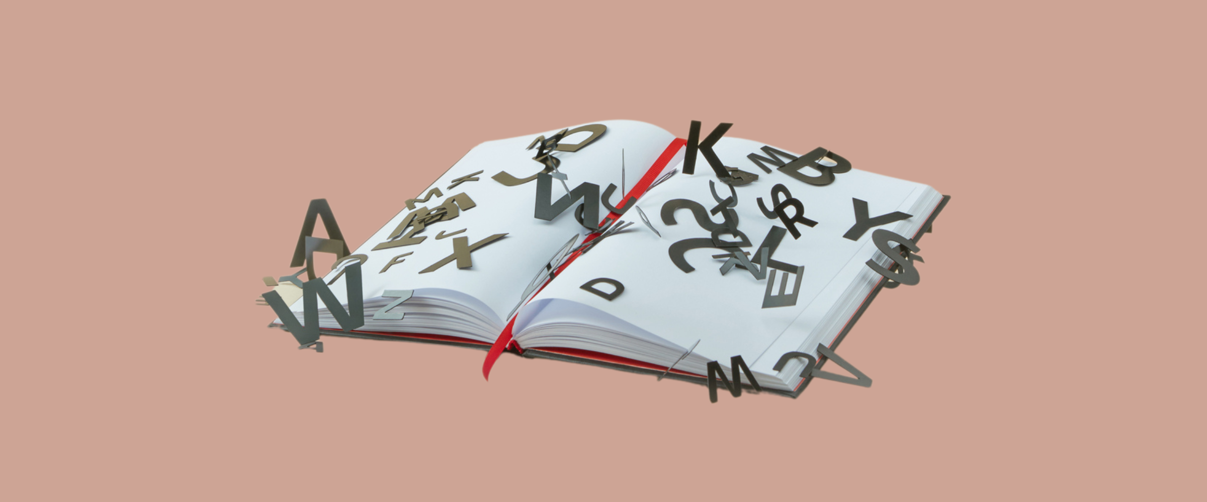 A book lies open with blank white pages covered in scattered black letters.