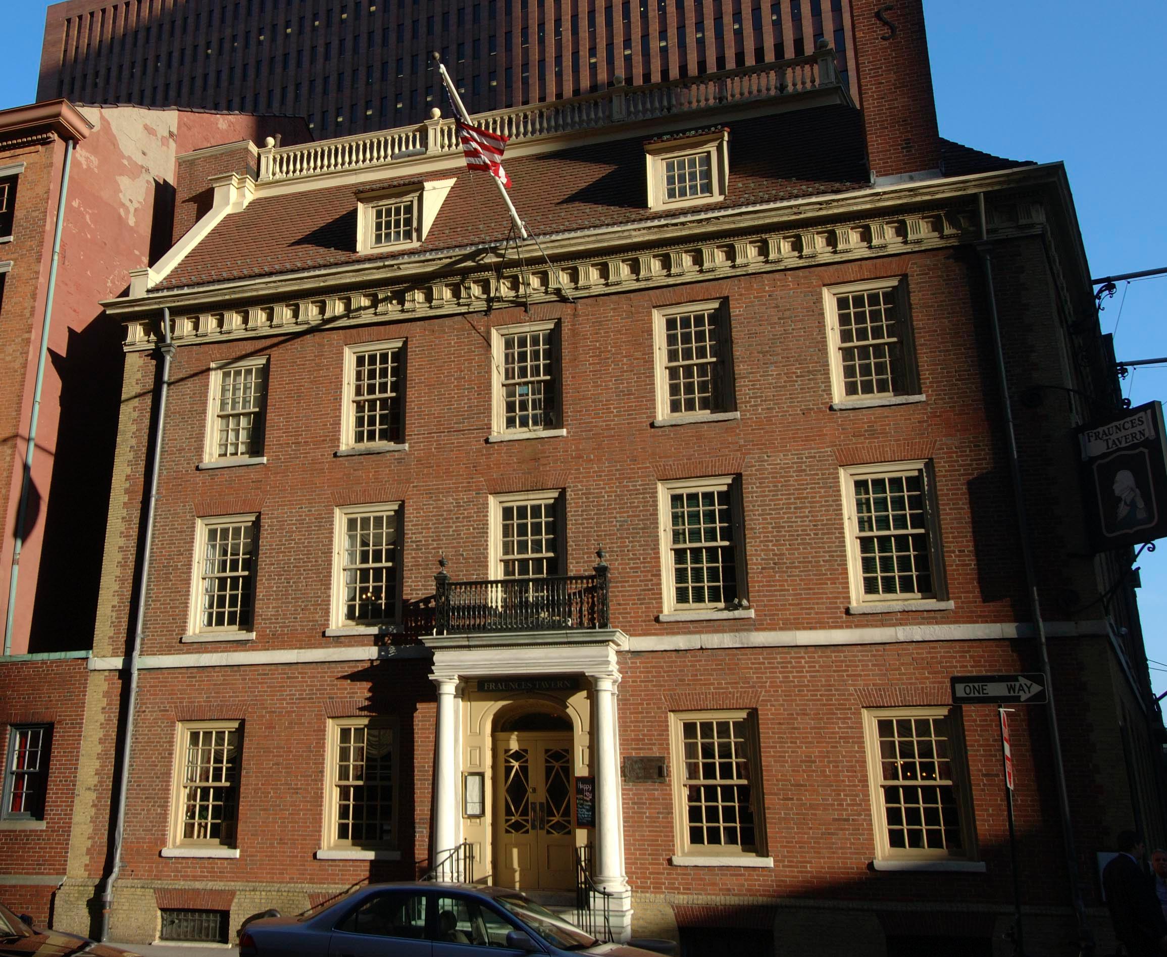 The front of the museum featuring 4 stories of windows and columns on either side of the front door.