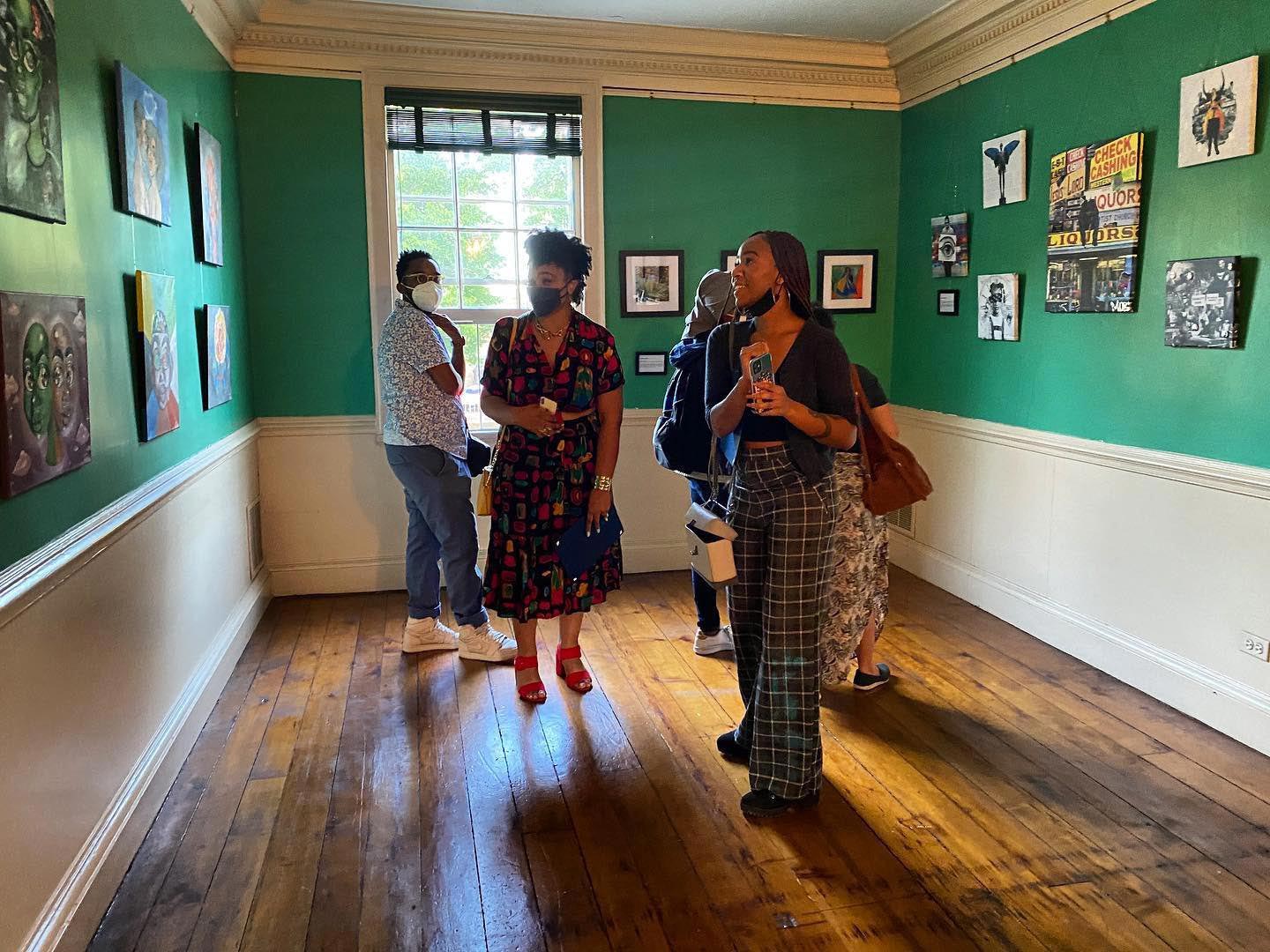 A group of visitors admire the art gallery.