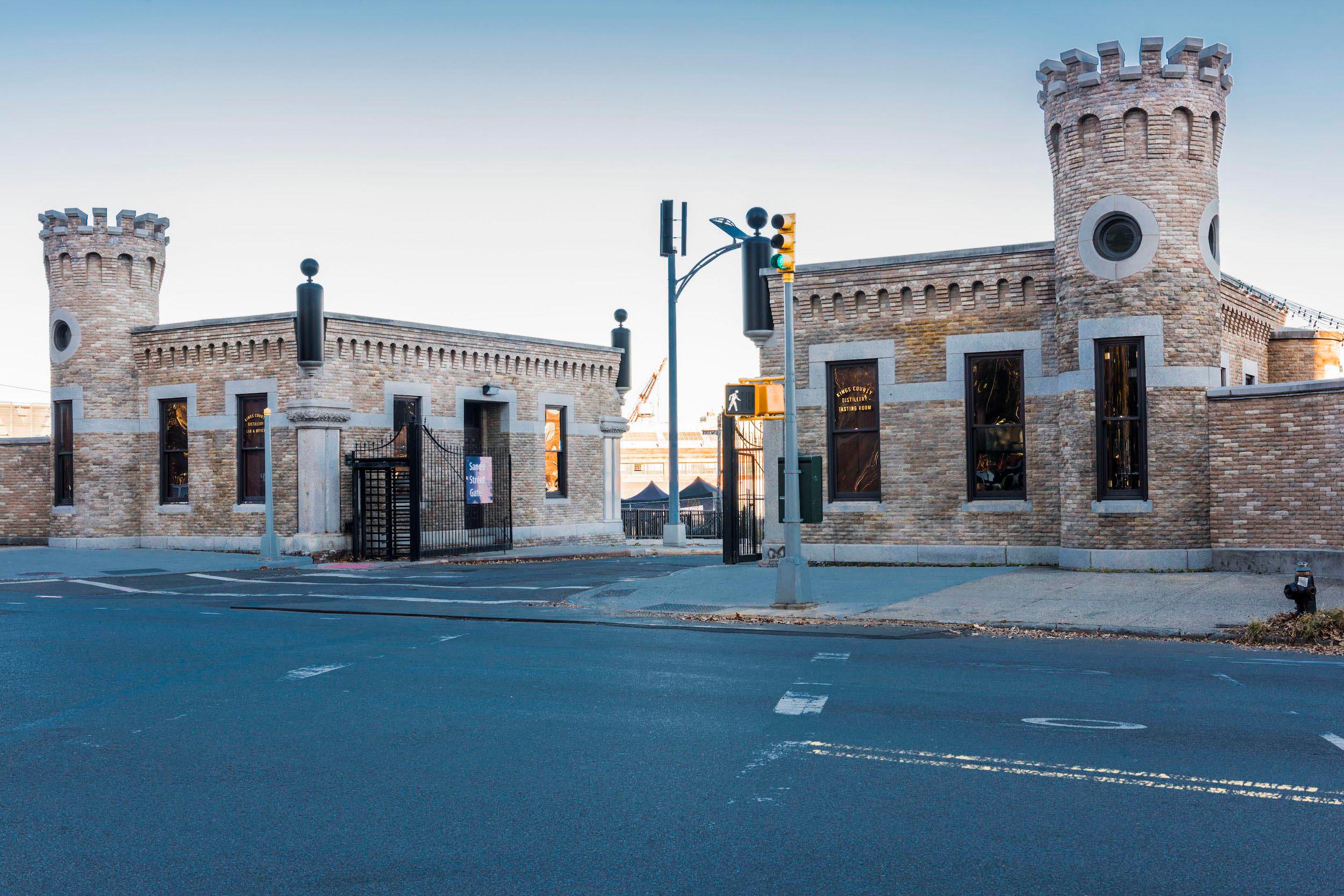 Stone gatehouses flank the entrance to Kings County Distillery.