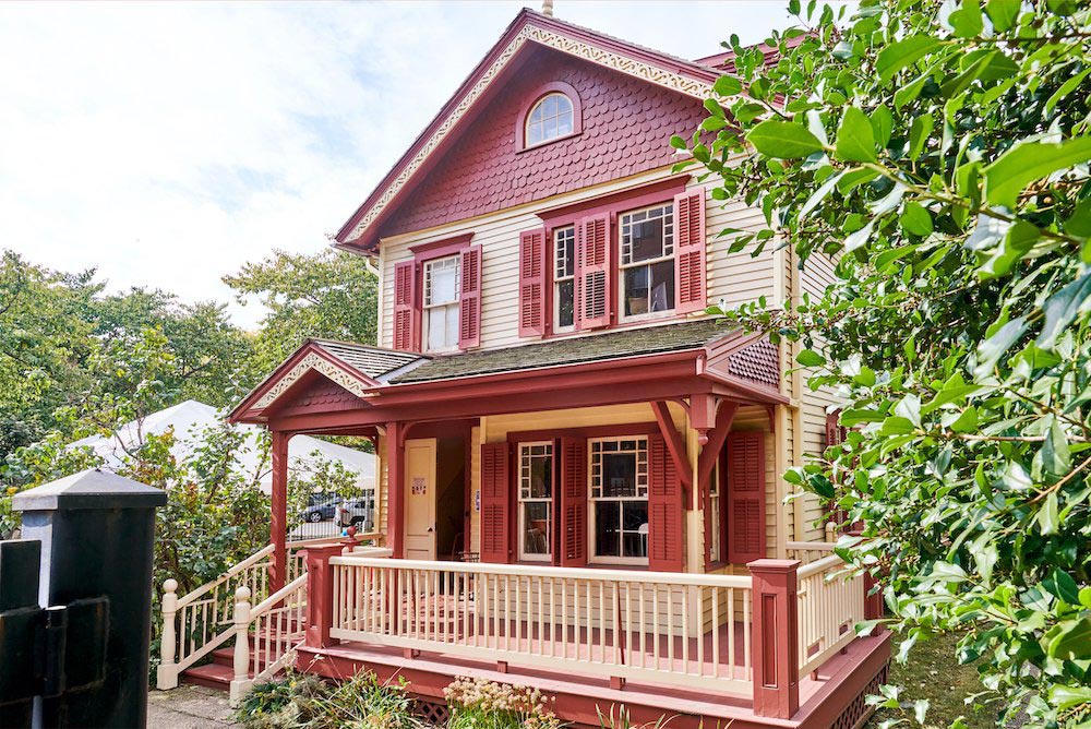 A Victorian-style house painted yellow and red.