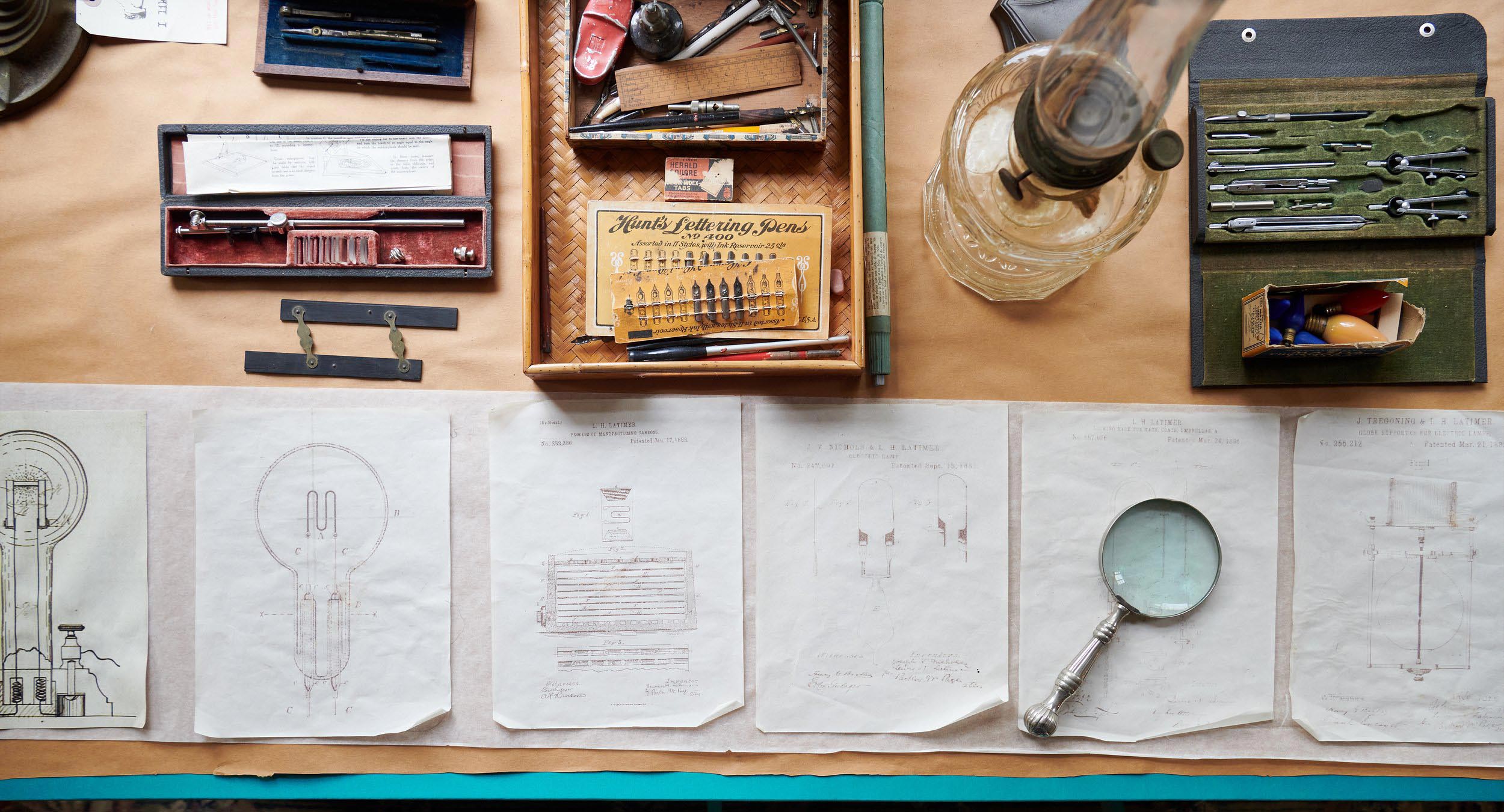 A row of hand-drawn diagrams and equipment provide information on the invention of electric light.