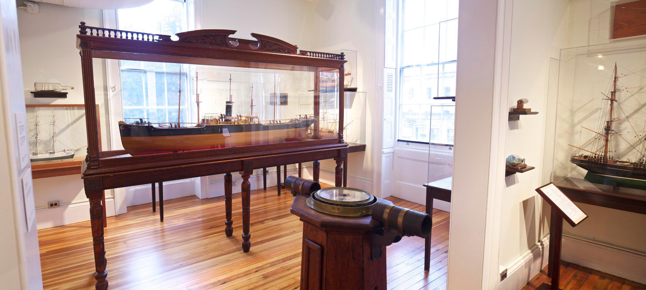An exhibit of a model ship in a glass case.