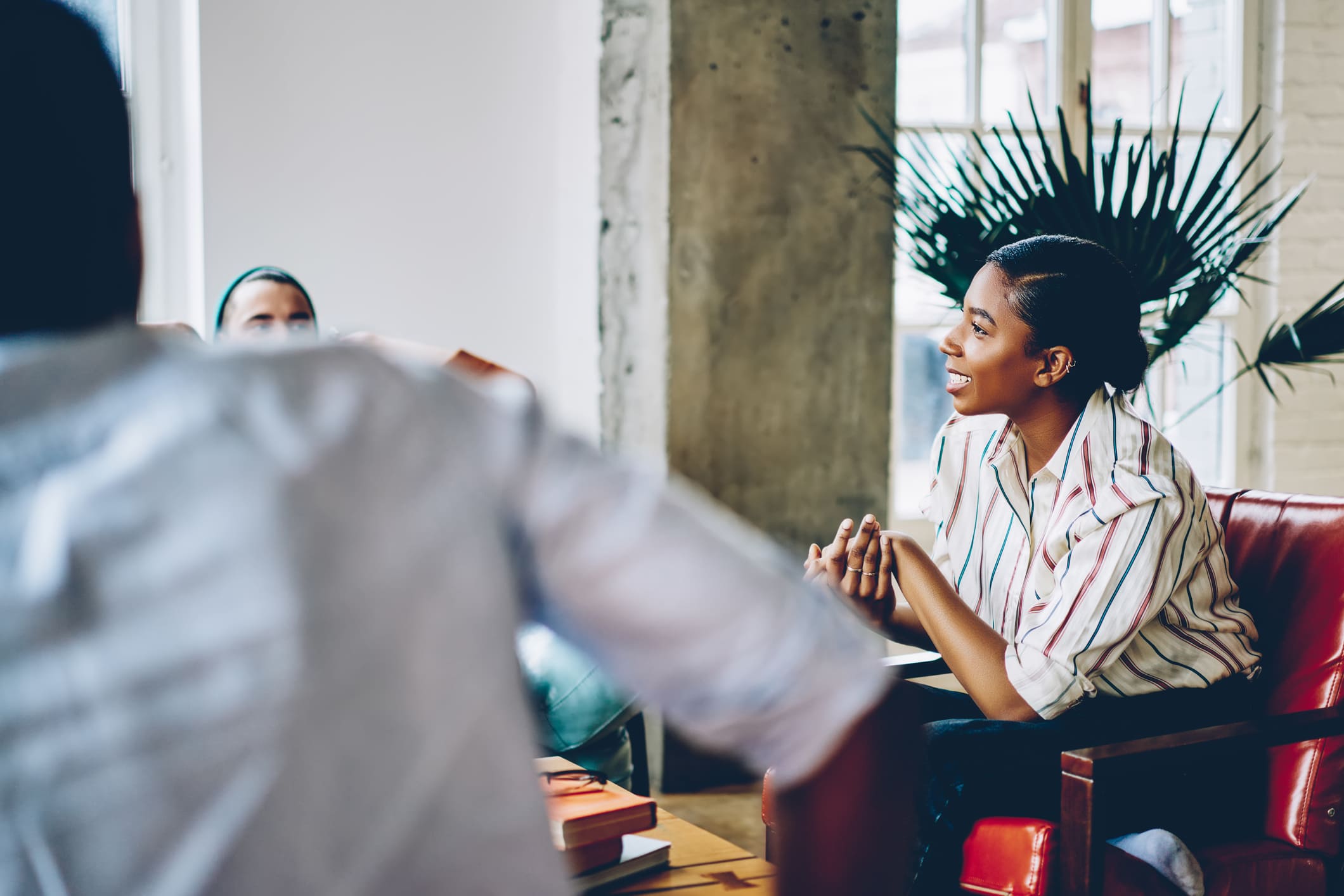 Frau unterhält sich auf einem Sessel