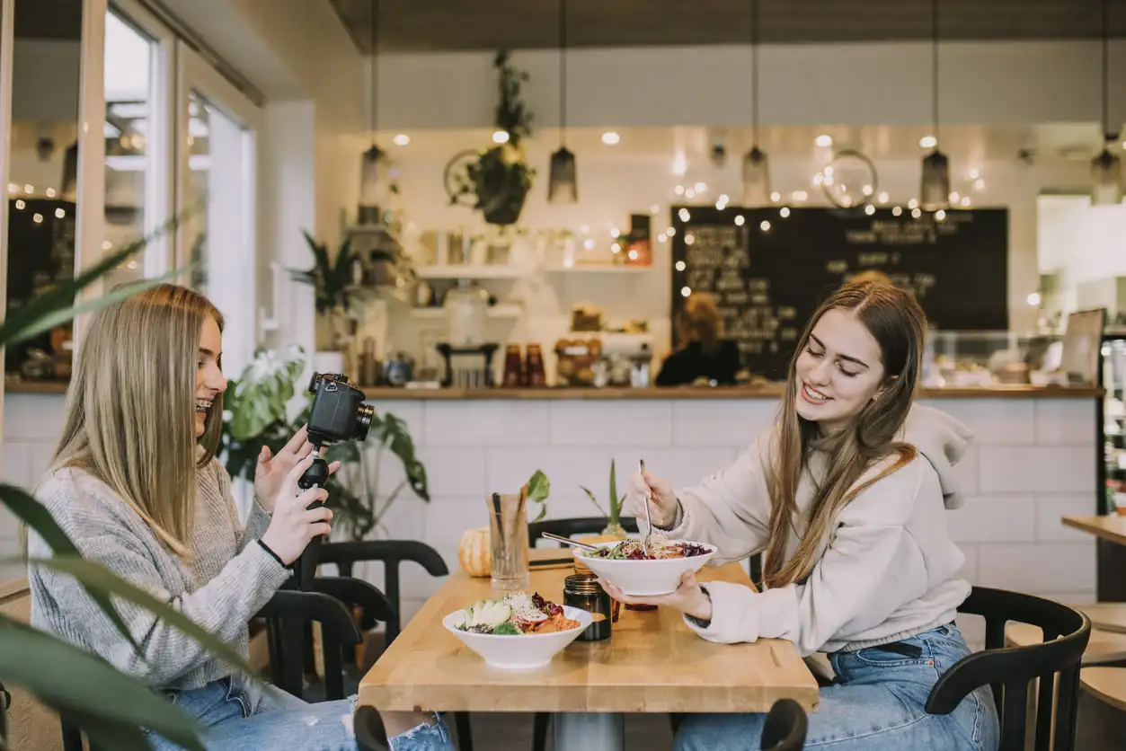 Influenceuses faisant une vidéo dans un restaurant