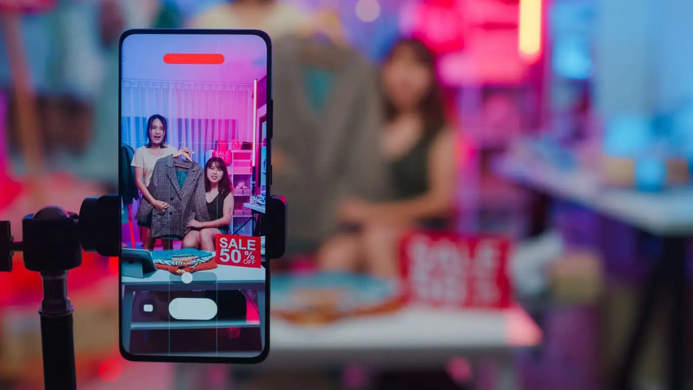  young Asian women live on their phones showcasing the new fashion clothing collection 