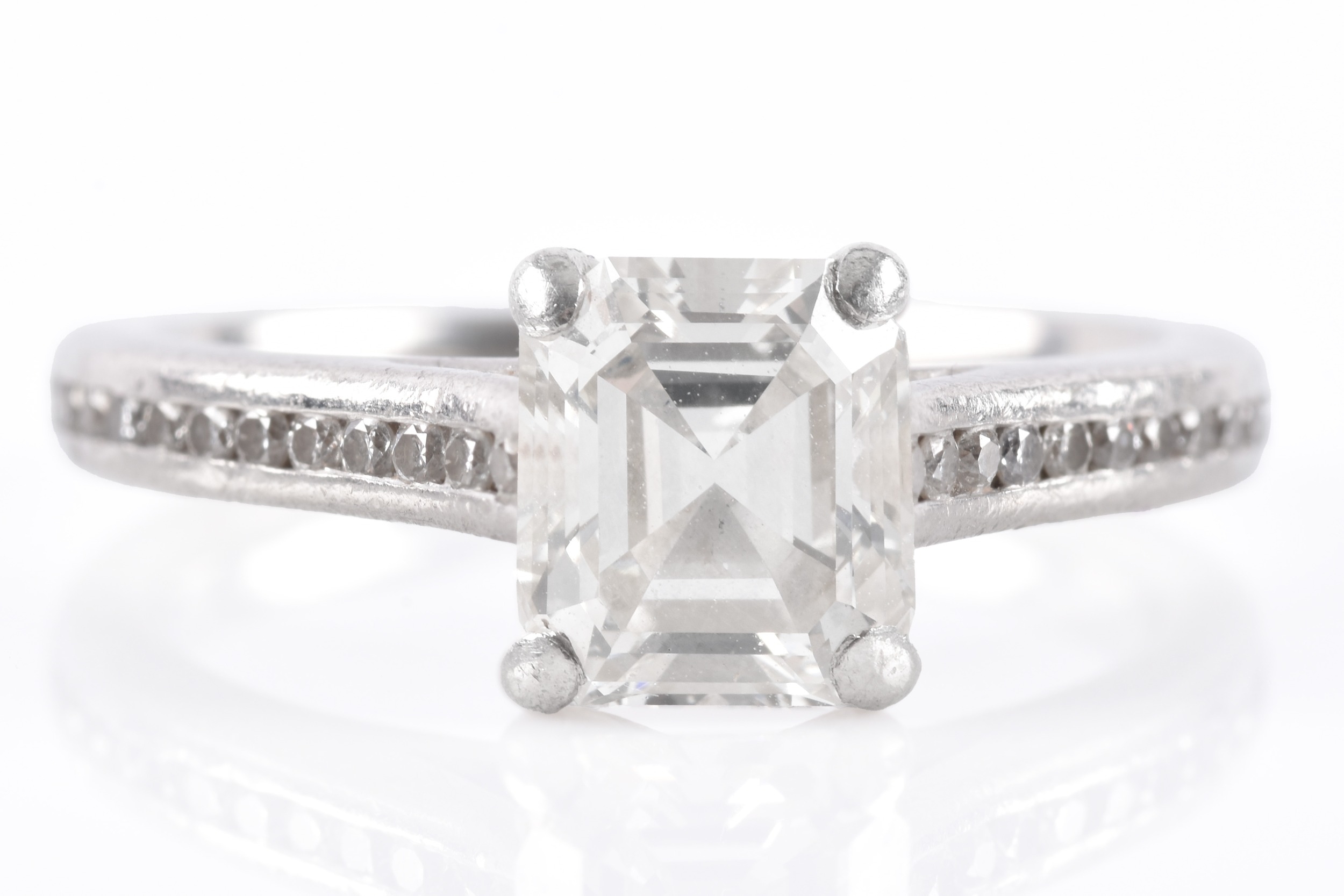 Emerald-cut diamond ring with diamond-set band, sold at Aubreys Auctioneers