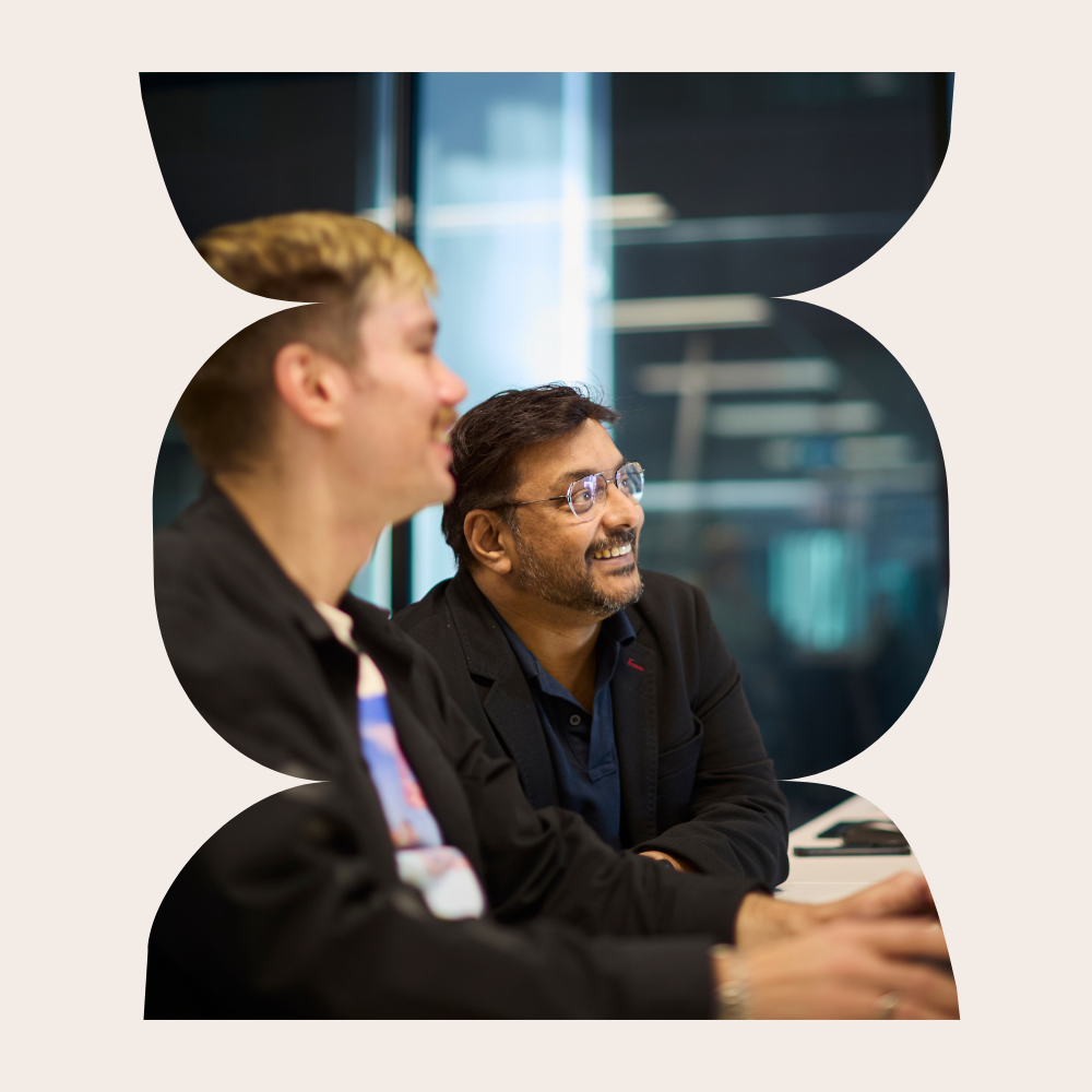 Two seisma employees collaborating during a meeting in a modern office environment.