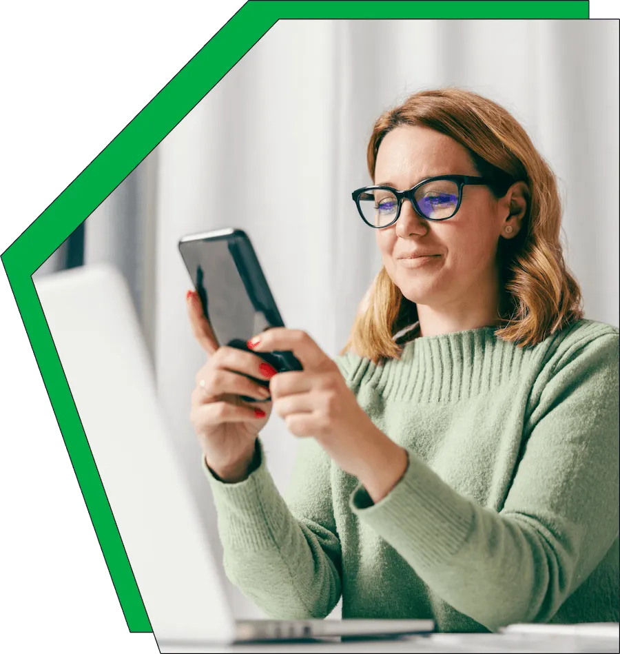 An image of a woman on her phone, smiling.