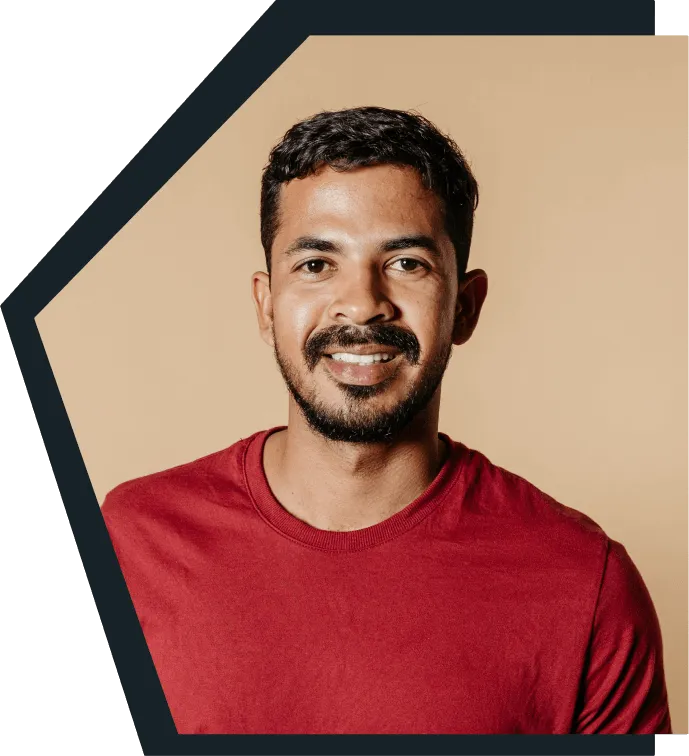 An image of a young man smiling at the camera. 