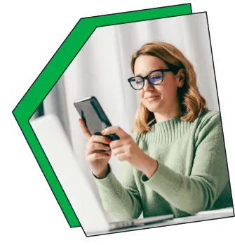 An image of a women on her phone, smiling.