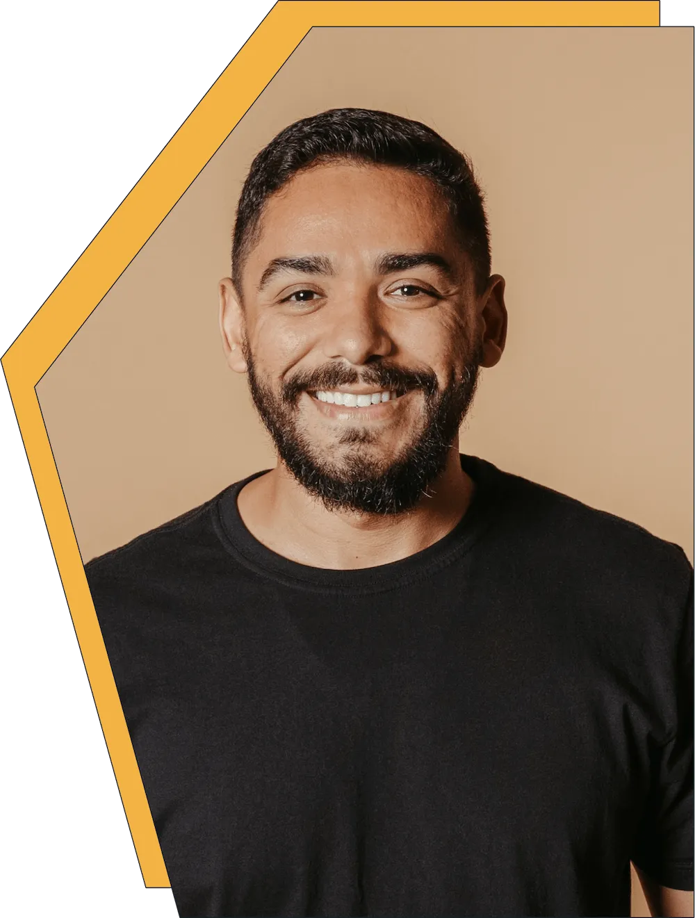 An image of a young man smiling at the camera. 