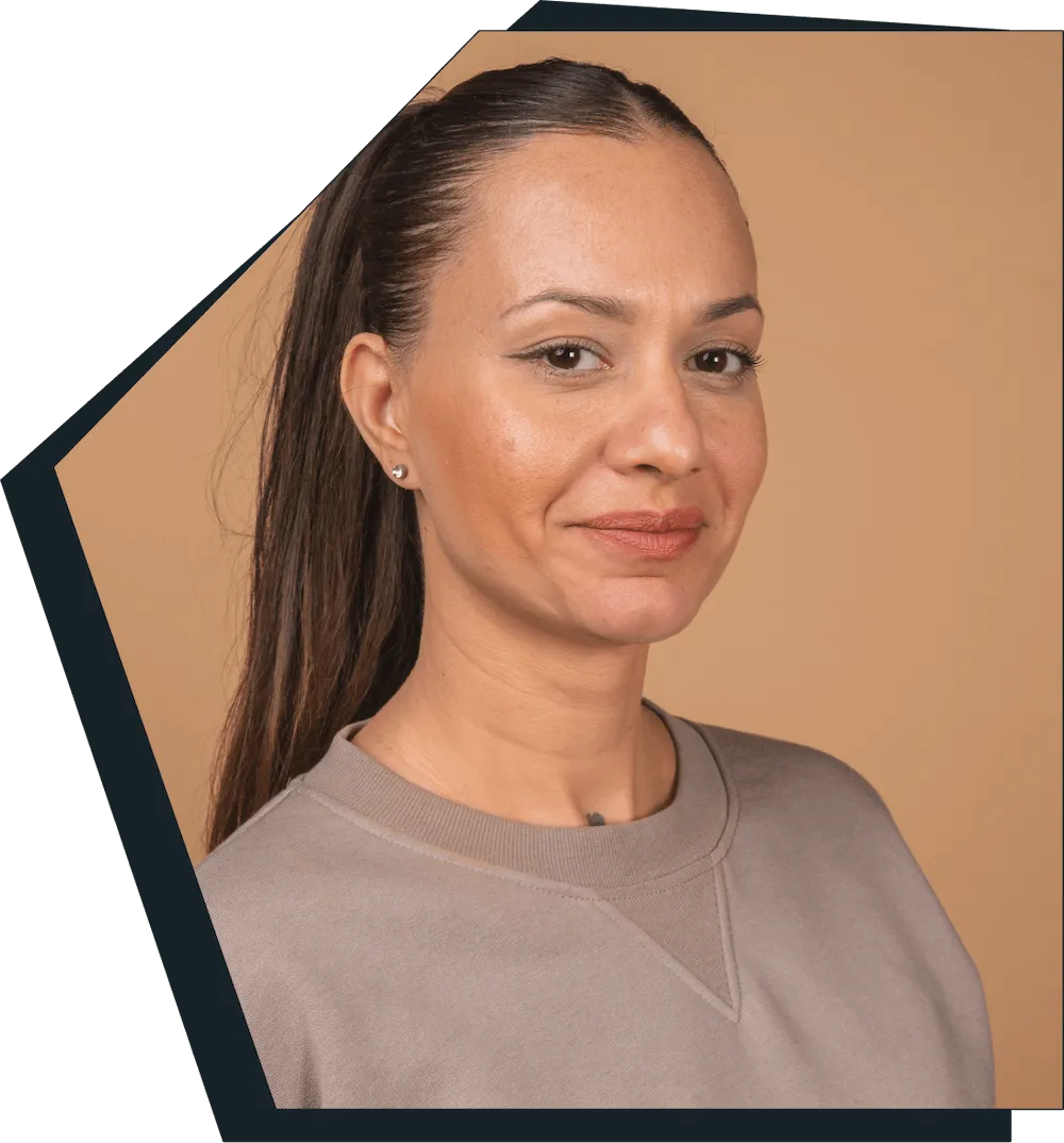 An image of a young woman smiling at the camera. 