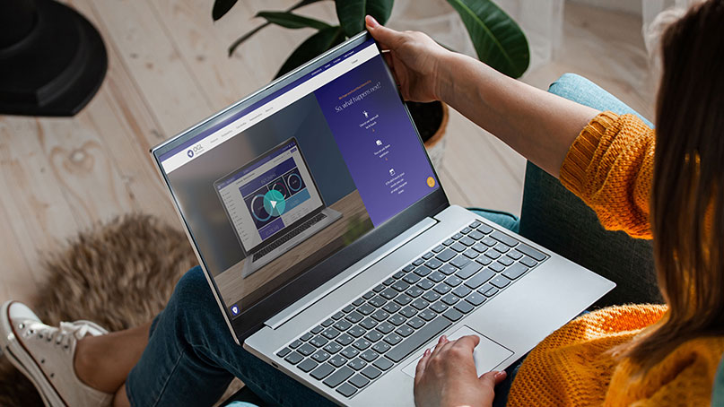 Woman watching demo video on laptop