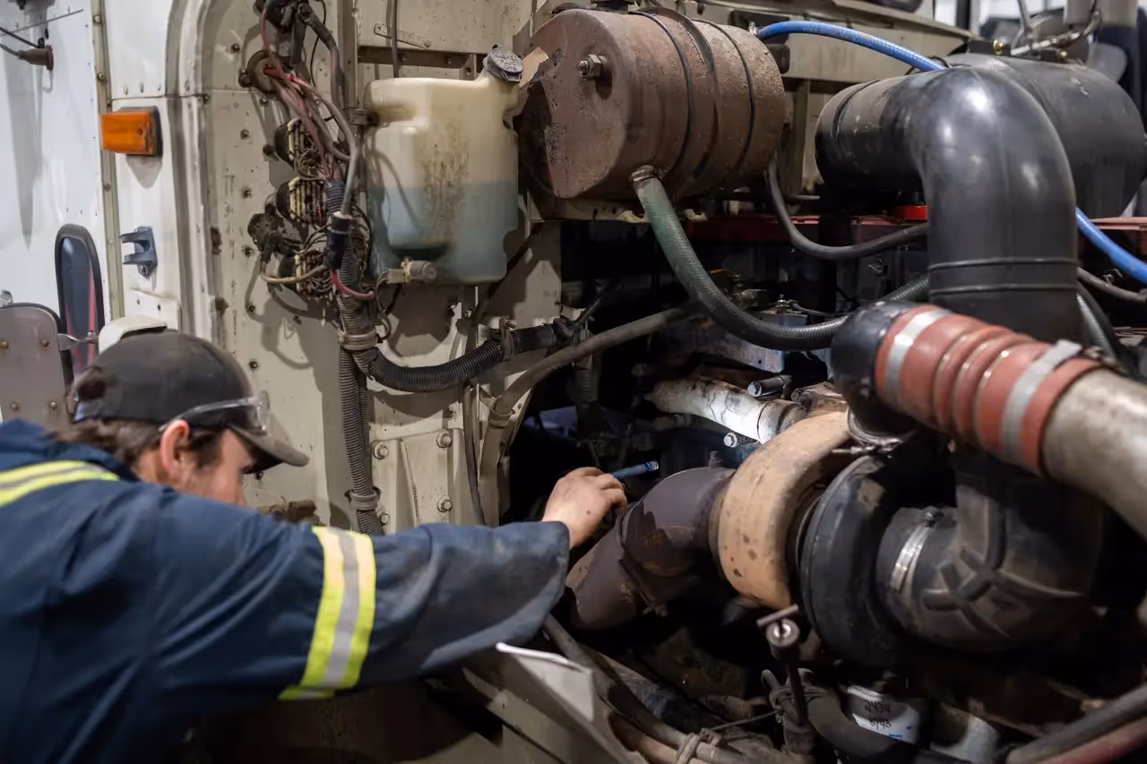 Diesel mechanic performing preventive maintenance services on semi-truck in Leduc, AB