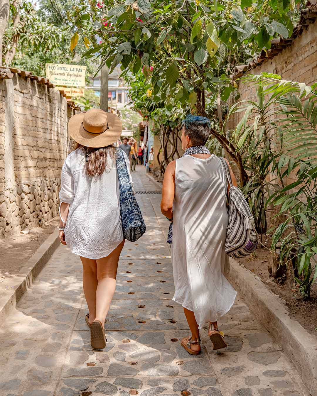 Two women walking on a sidewalk in Guatemala
