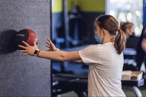 Woman throwing the ball into the wall