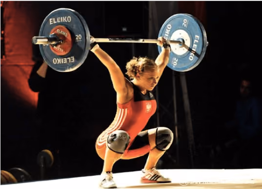 Woman lifting weights with black suit