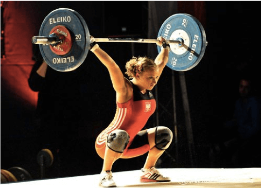Woman lifting weights with black suit