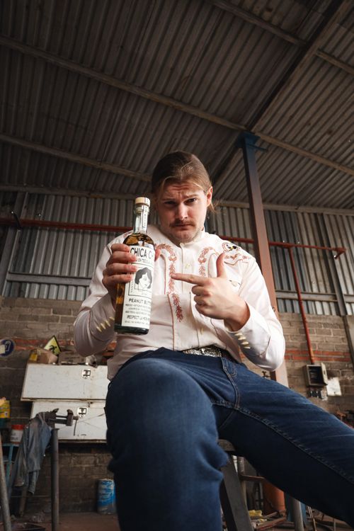 Caleb pointing at bottle of Chica Chida