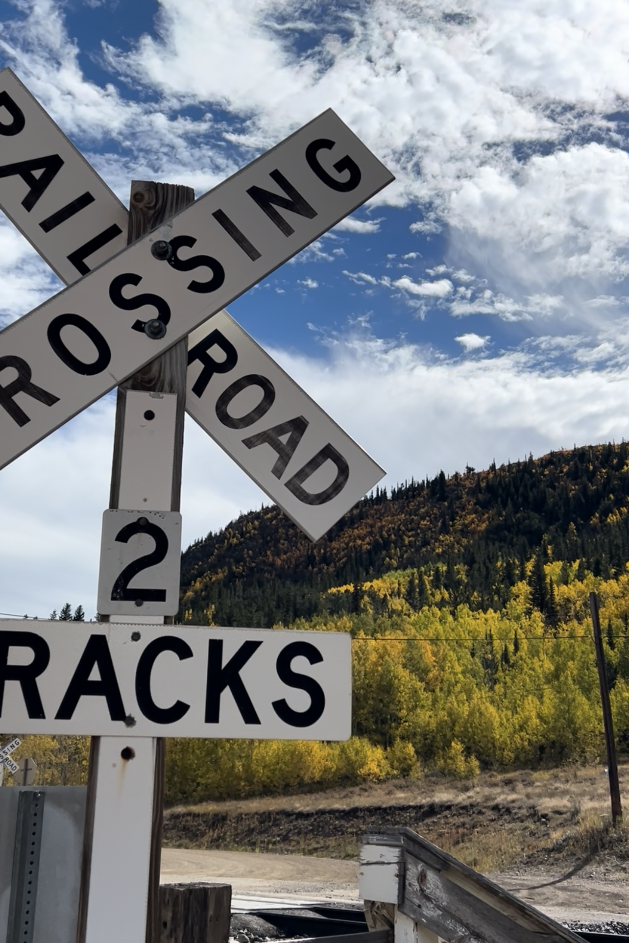 Railroad crossing sign in front of Aspen trees along the Moffat Tunnel railroad tracks