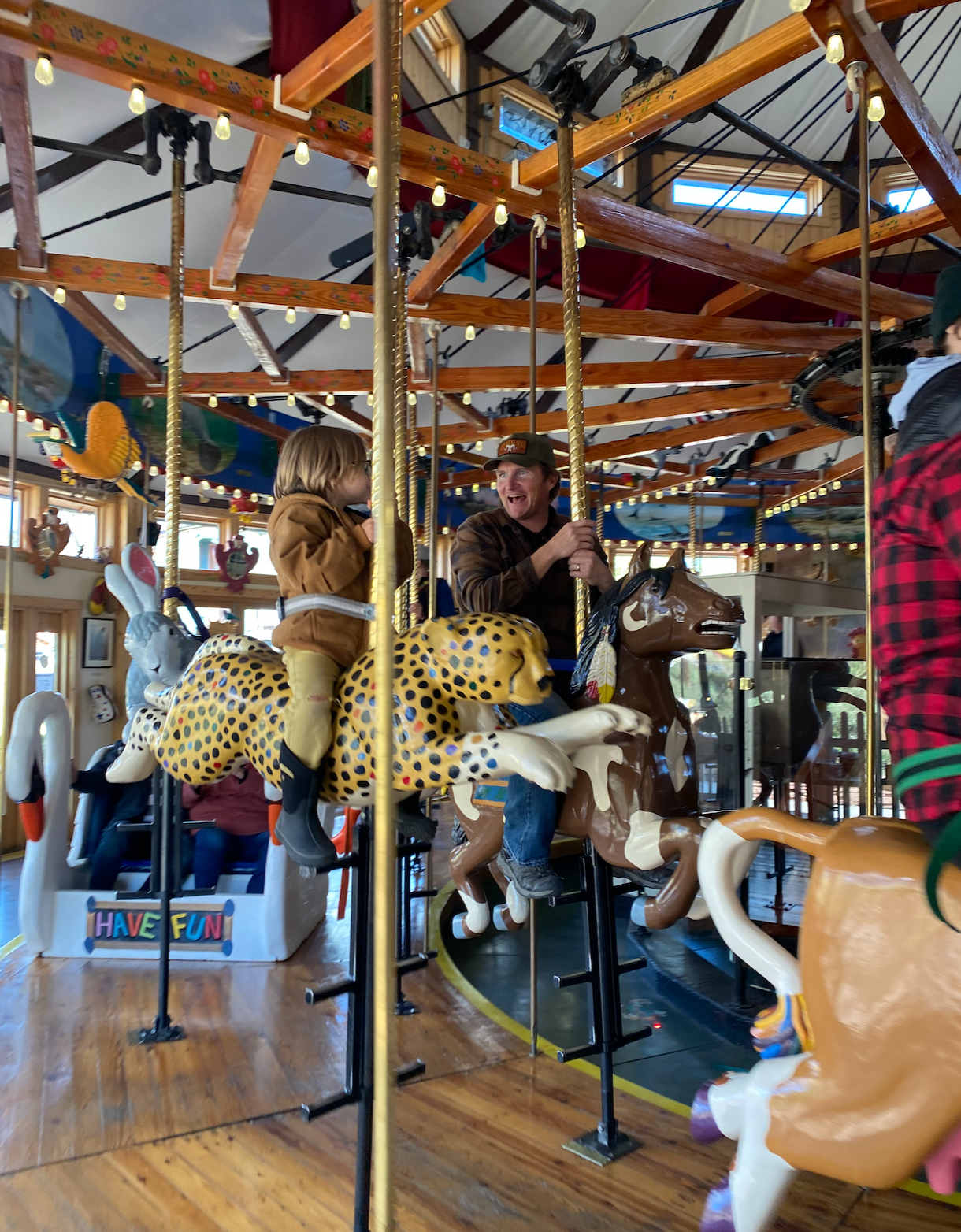 Man and boy on a carousel at the Carousel of Happiness, Nederland Colorado