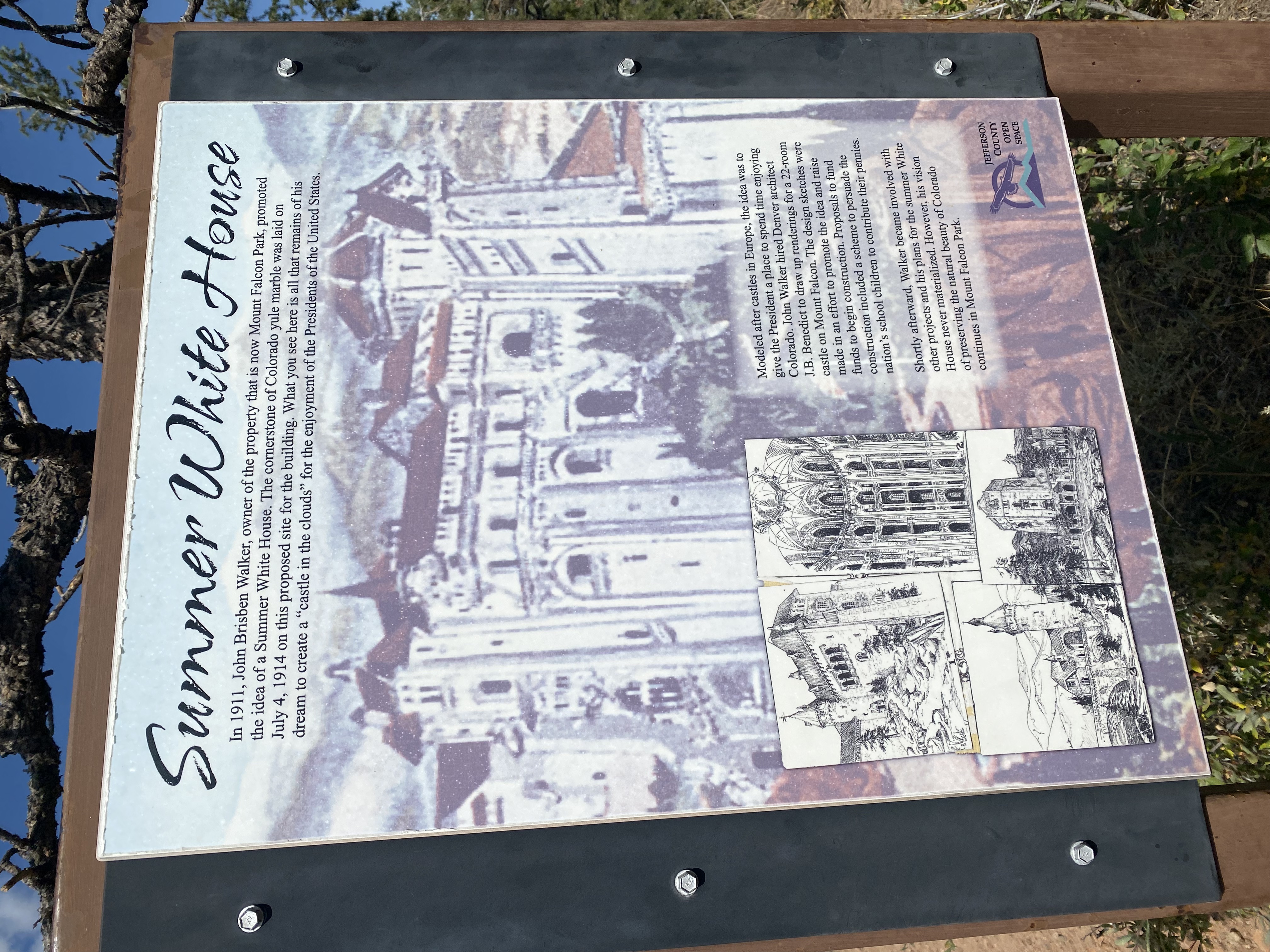 Informational sign titled 'Summer White House' with text and sketches describing John Brisben Walker's 1911 plan for a castle-like summer residence in Mount Falcon Park, Colorado.