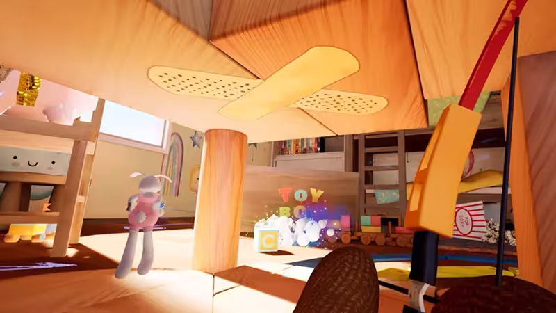 View from under a wooden table looking out onto a children's playroom with toys, including a toy bunny, blocks, and a popcorn box.