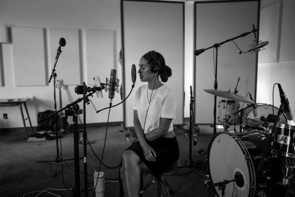 Moriah in the studio recording music.