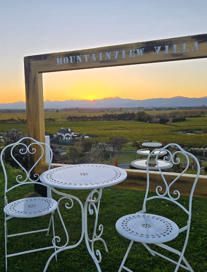 Pink and orange sunset clouds over the Richmond Range and Marlborough wine valley, viewed from Mountainview Villa Luxury Lodge in Blenheim, New Zealand.
