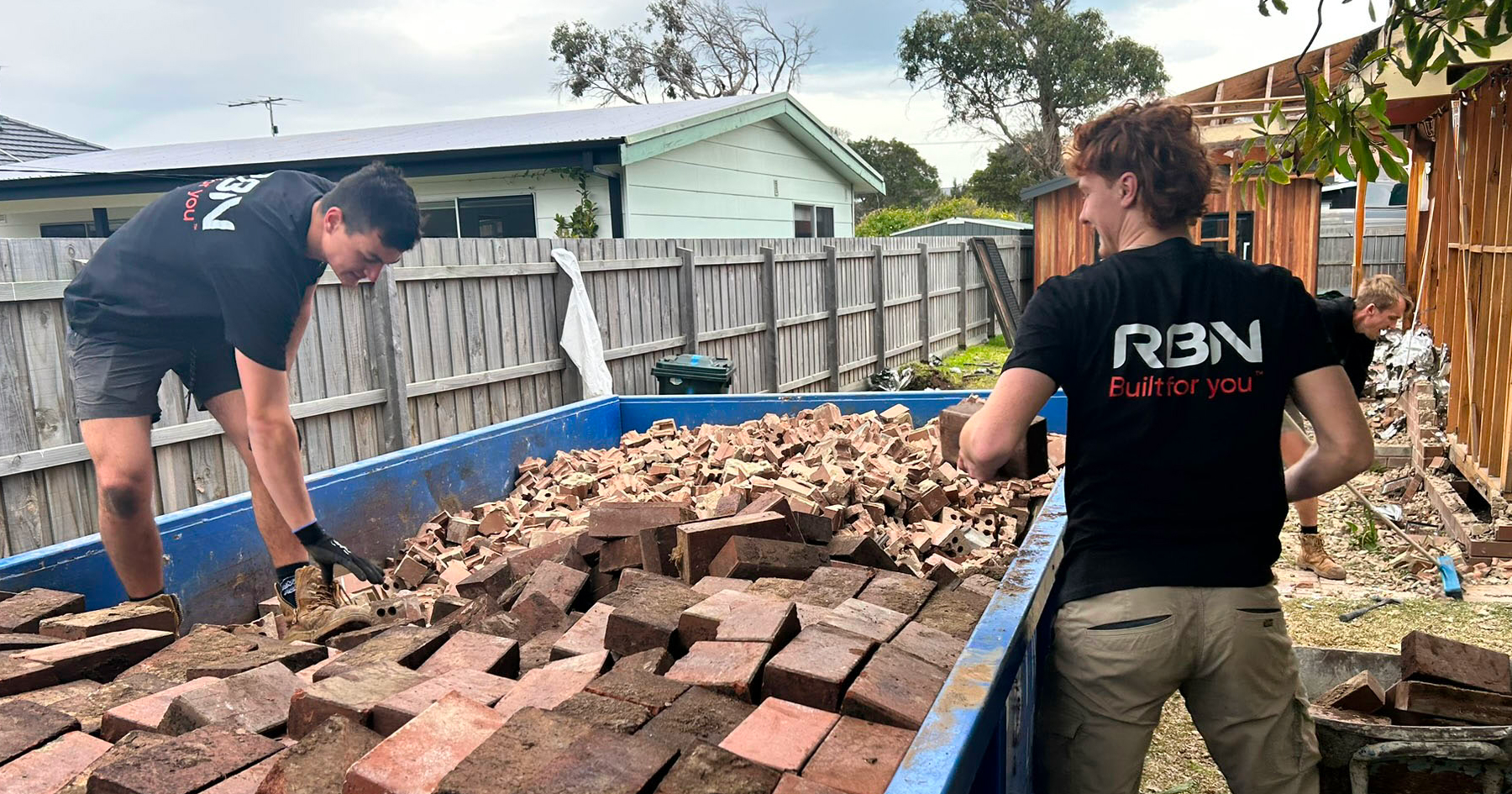 Workers holding bricks