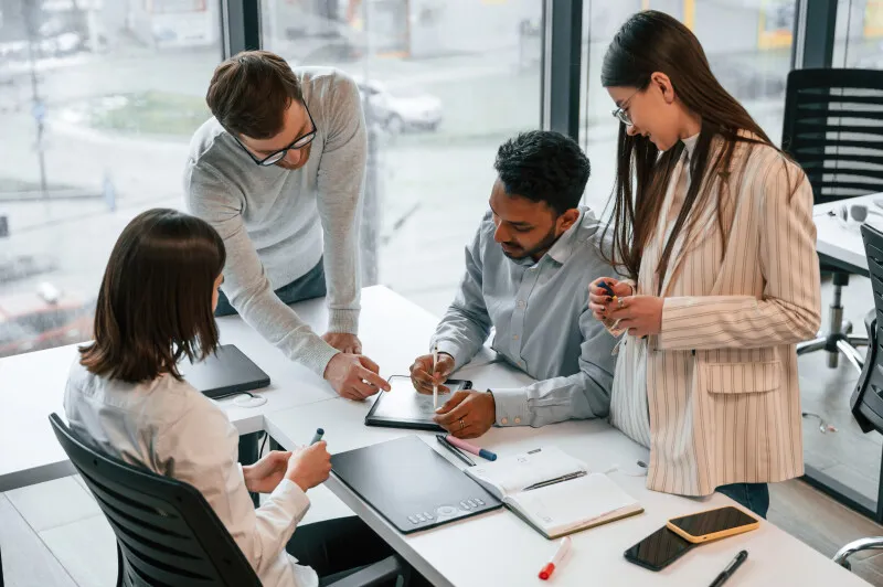 Employees discussing contract management software